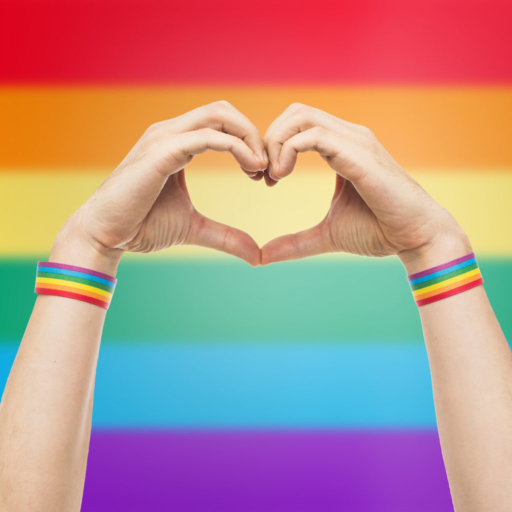 Holding hands like a heart with a rainbow flag in the background. You can get LGBTQIA+ Therapy St. Petersburg or lgbtqia+ counseling in st. petersburg, fl here at ME-Therapy. 33701