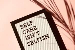 Sign: Self-Care isn't selfish. Online therapy in Florida with a skilled St. Pete therapist can help.