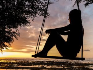Person sitting on swing overlooking the ocean in St. Petersburg, FL. You can get therapy for anxiety or anxiety treatment in St. Pete with a skilled counselor in St. Petersburg, FL here. Online therapy in Florida can help with anxiety and more!