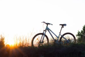 Bike on a field with sun in background. A St. Pete therapist shares about anxiety treatment in St. Petersburg, FL with online therapy in Florida. Anxiety help is here for you with therapy for anxiety with a St. Petersburg therapist.
