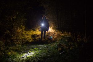 Person holding flashlight in the dark. Read on for myths about St. Pete counseling, maternal mental health in St. Petersburg, FL and couples therapy through online therapy in Florida from a St. Pete therapist. 