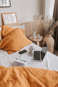Bed with laptop and journal. Get Online Therapy in Florida with a therapist in st petersburg fl for couples therapy, sex therapy, anxiety treatment and more.